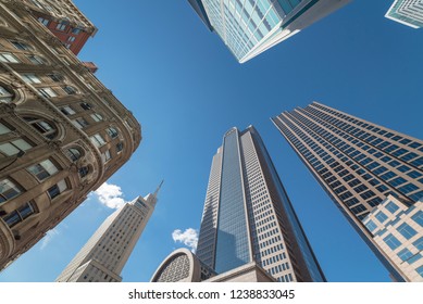 Upward view of skyscrapers against blue sky in the business district area of downtown Dallas, Texas, USA.