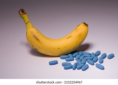 Upwards yellow banana with many blue erection pill, concept of the effect of the blue pill for male problems