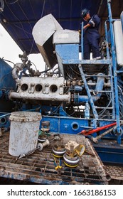 Uralsk Region, Kazakhstan - May 24 2012: Oil Deposit Zhaikmunai. Oil Drilling Rig. Serviceman Fixing Broken Mud Pump Engine. Baker Hughes Equipment.