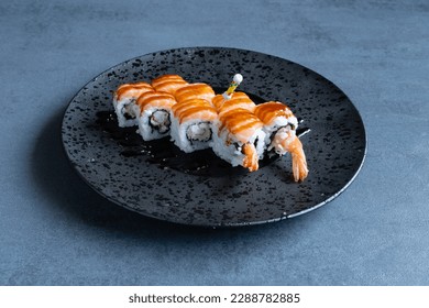 Uramaki Tiger with fish and rice, preparation with Japanese Sushi technique. - Powered by Shutterstock