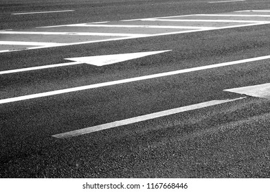 Urban asphalt road with arrows and marks on it. Traffic signs and symbols. - Powered by Shutterstock