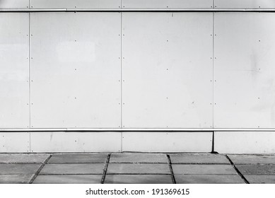 Urban Background Interior With White Metal Wall And Concrete Pavement