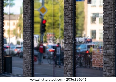 urban background with large shop windows reflecting the street with people and traffic, closeup