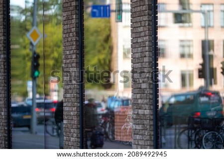 urban background with large shop windows reflecting the street with people and traffic, closeup