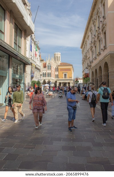 Urban background. View\
of the historic city center. People walking on the via Roma with\
the Pedrocchi café background. Vertical image. September 11, 2021,\
Padua, Italy