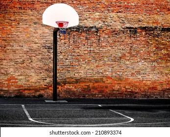 Urban Basketball Court In Neighborhood With Old Buildings            