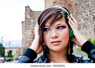 Urban beautiful girl, concentrated in music