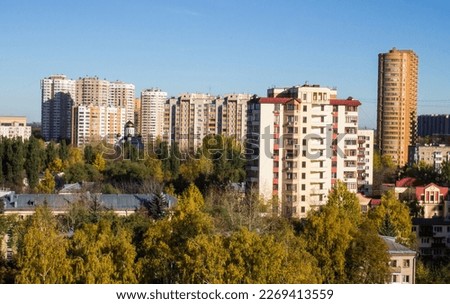 Urban beautiful landscape - panoramic view of residential multi-storey modern houses among autumn trees on a sunny October day in Reutov Moscow region and copy space