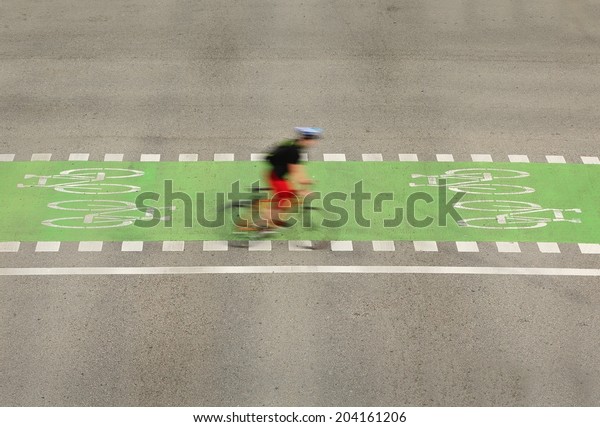 Urban Bicycle Crossing, Vancouver. A cyclist\
using the designated bicycle lane in downtown Vancouver, British\
Columbia, Canada.
