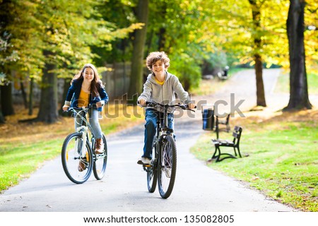 Urban biking - teens and bikes in city park