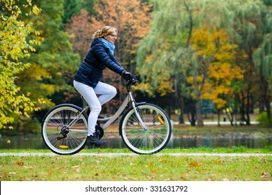 Urban Biking - Woman Riding Bike In City Park 