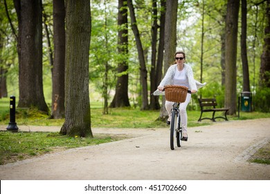 Urban Biking - Woman Riding Bike In City Park