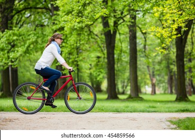 Urban Biking - Woman Riding Bike In City Park 