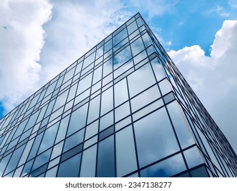 Urban building design concept, bottom view of modern skyscraper in business district. Buildings glass window, downtown area.