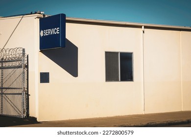 Urban building with fence and sign - Shutterstock ID 2272800579