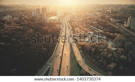 Urban Car Road Traffic Congestion Aerial View. City Street Motion Lane, Drive Navigation Overview. Busy Cityscape Speed Route with Forest Park Around. Travel Concept Drone Flight Shot