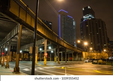 Urban City Street Corner With Vintage Train Bridge And Skyscrapers In Chicago At Night