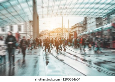 Urban city view of people crowd walking outside of bus station - Concept of modern, rushing, urban, city life, business, shopping - Focus on center pedestrians feet - Defocused radial effect
