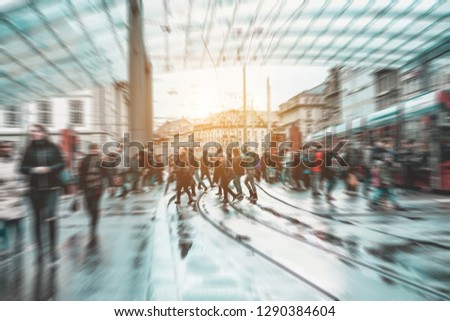 Urban city view of people crowd walking outside of bus station - Concept of modern, rushing, urban, city life, business, shopping - Focus on center pedestrians feet - Defocused radial effect