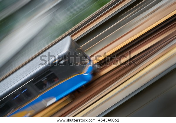 Urban\
Commuter Rail. An elevated commuter rail car speeds along a track.\
Motion blur.\
\
                              \
