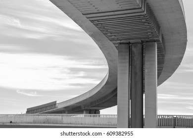 Urban concrete flyover in black and white curving to the left