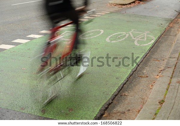 Urban Cycle Path, Vancouver. A\
cyclist using the designated bicycle lane which is separated from\
vehicle traffic in downtown Vancouver, British Columbia,\
Canada.