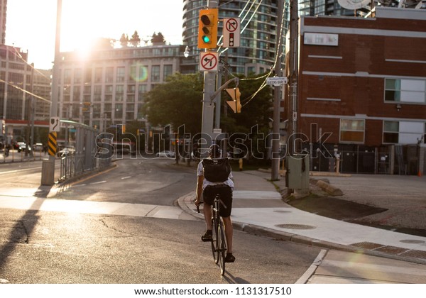 Urban cyclist with\
sunset