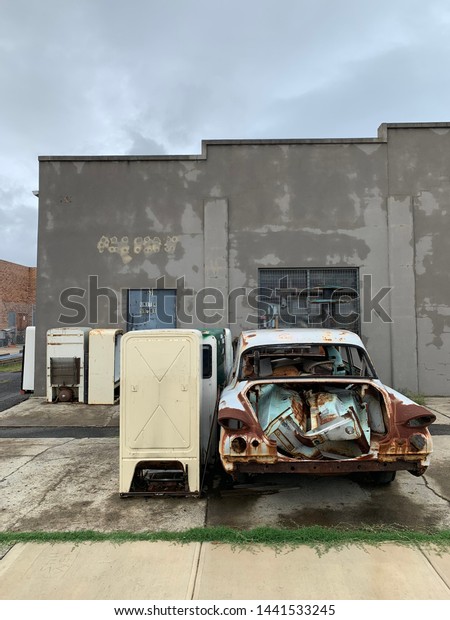 Urban factory with\
car and vintage fridge