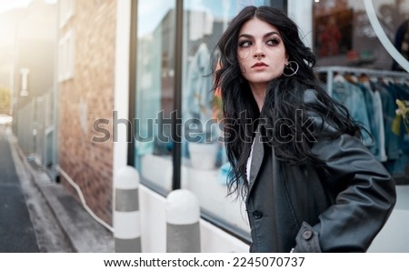 Urban fashion, style and a woman on the street at shop window, punk streetwear outside designer boutique. Beauty, make up and gen z fashion model or rock influencer in the city at store window.