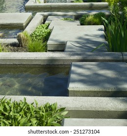 Urban Garden Water Feature Of Concrete And Vegetation