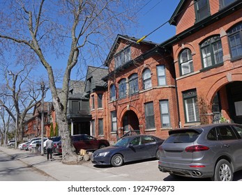 Urban gentrified street with old Victorian houses and parking allowed on front pavement. - Powered by Shutterstock