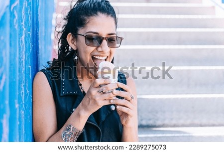 Urban girl eating an ice cream cone, A girl eating an ice cream outdoors, girl enjoying an ice cream, close up of a woman holding an ice cream