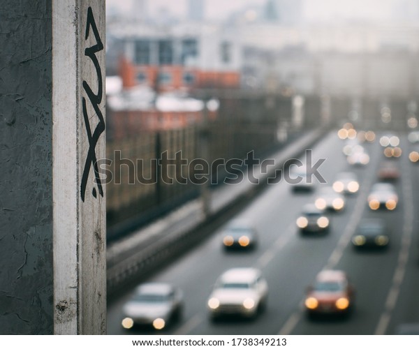 urban graffiti on the background of blurred\
car traffic in the\
background