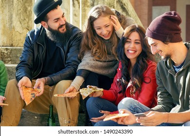 Urban Hipster Friends Eating Pizza Slices Sitting Outside In Town. College Students Enjoying  Junk Food Together.