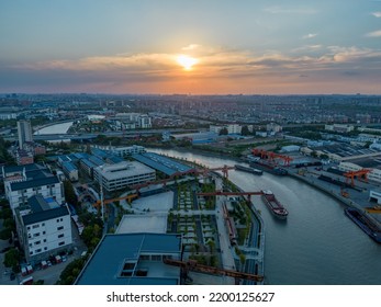 Urban Industrial Canal In The Sunset Sky