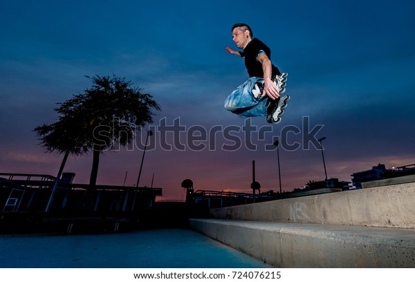 Urban Inline Skater Jumps Street Stock Photo (Edit Now) 724076215