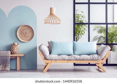 Urban Jungle In Bright White And Blue Living Room Interior With Scandinavian Futon Sofa