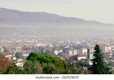 Urban Landscape. Aerial View Of The City Of Vittorio Veneto With The Mountains In The Background. Day With Haze.