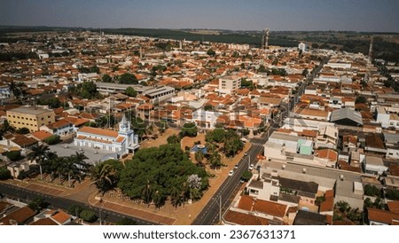 Urban landscape in aerial view of a small town, with the church and the square on a sunny morning on an ordinary day, taking in everything up to the horizon - Guapiacu - Sao Paulo - Brazil