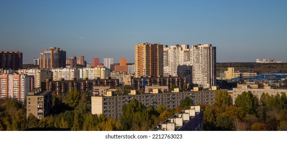 Urban landscape - panoramic view of residential multi-storey modern houses among autumn trees on a sunny October day and copy space - Shutterstock ID 2212763023