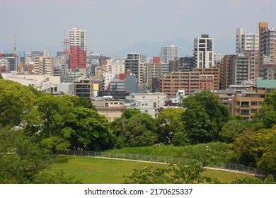 Urban landscape surrounded by greenery and buildings viewed from the castle tower of Fukuoka Castle Ruins: Fukuoka City, Fukuoka Prefecture, Japan