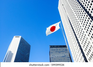 Urban landscape in Tokyo, buildings in Shinjuku, Japan flag,.
