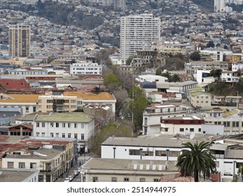 An urban landscape with white and colored houses on the hill in a chilean city with a hight population density - Powered by Shutterstock