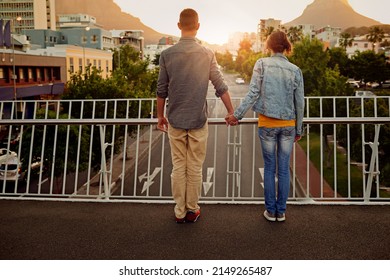 Urban Love. Rearview Shot Of A Couple Standing Together On A City Bridge And Looking At The View.