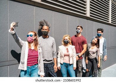 Urban Milenial People Taking Selfie With Face Mask On Covid Fourth Wave - Trendy Guys And Girls Posing Against Wall At City Center - College Students Having Break At University Campus - Bright Filter