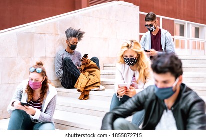 Urban Milenial Students Using Smart Phones With Face Mask On Covid Second Wave - Serious Guys And Girl Watching Video On Smartphone - College Friends Busy At University Break - Bright Contrast Filter