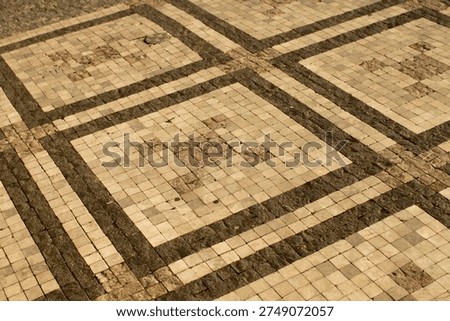 Urban mosaic pavement with square pattern, weathered beige tiles, subtle grout lines, quiet plaza atmosphere, soft daylight highlighting texture