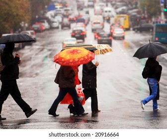 urban people cross the street on the rain - Powered by Shutterstock