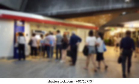 Urban People Getting In Line In The Long Queue For Buying Train Ticket In Evening After Working Day At Ticket Vending Machine On Station, Which Area Is Business District.