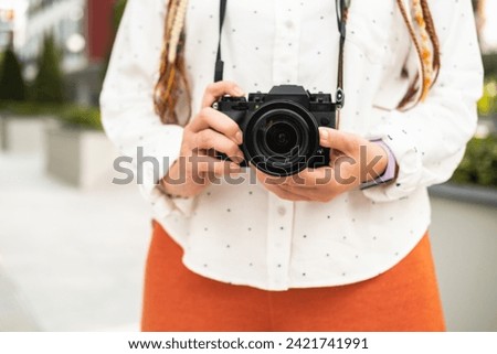 Urban photographer with colorful hair ready to capture moments on a digital camera.